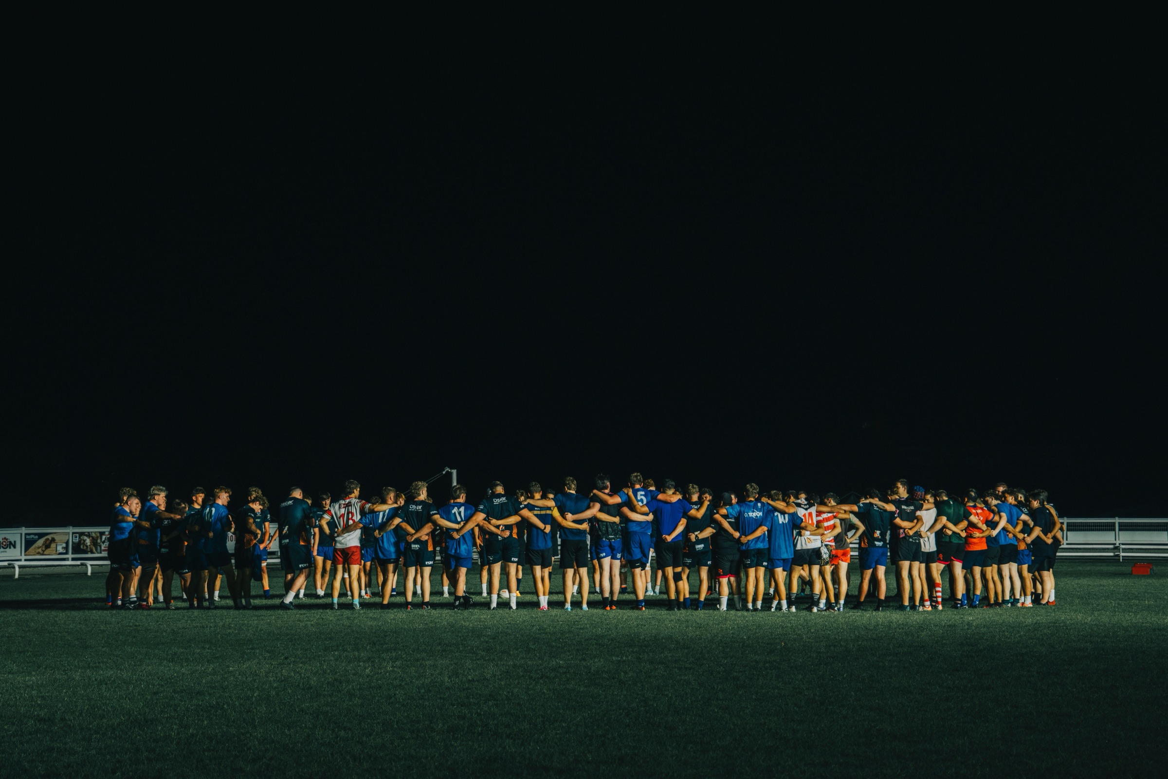 Team huddle under lights