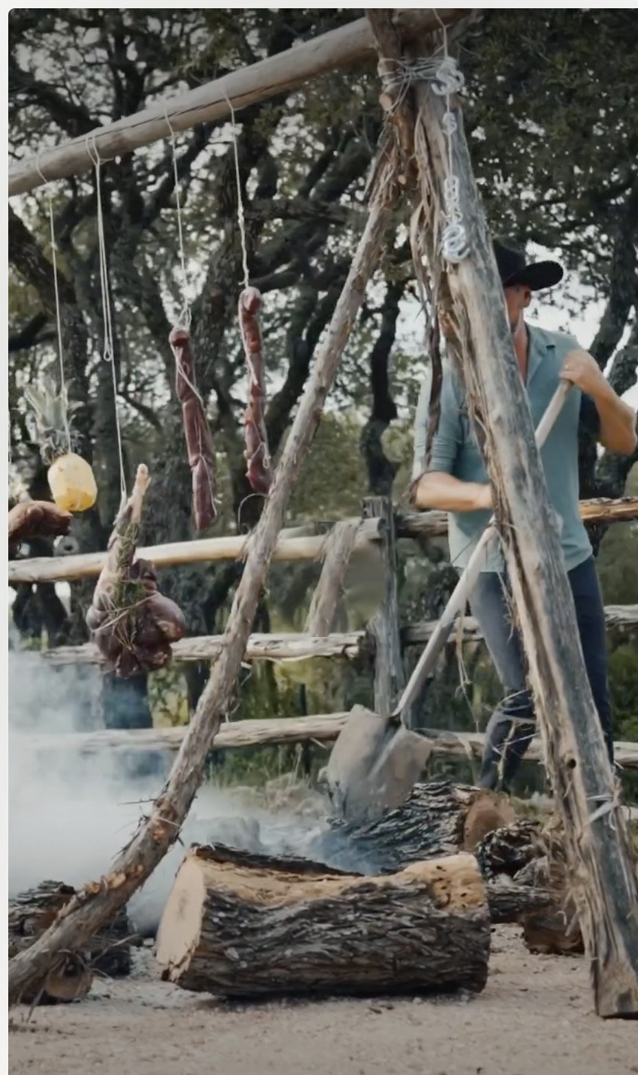 The feel — open-fire cooking, meat curing on a timber frame over the coals